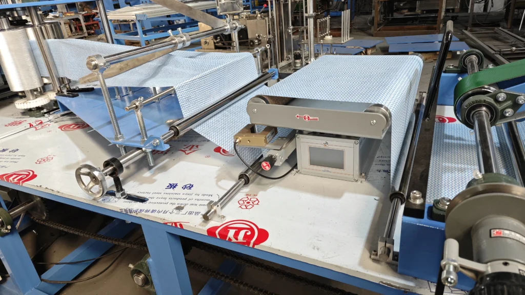 Close-up of the web guiding system on the YWJ-AF Pro non-woven folding machine