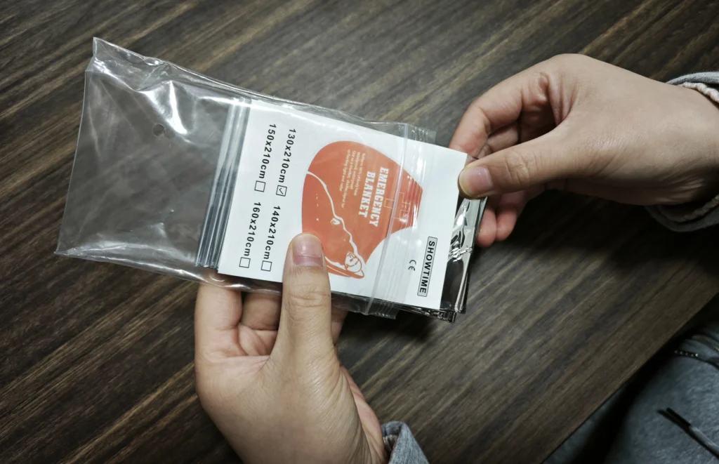 emergency blankets are manually inserted into PE self-sealing bags
