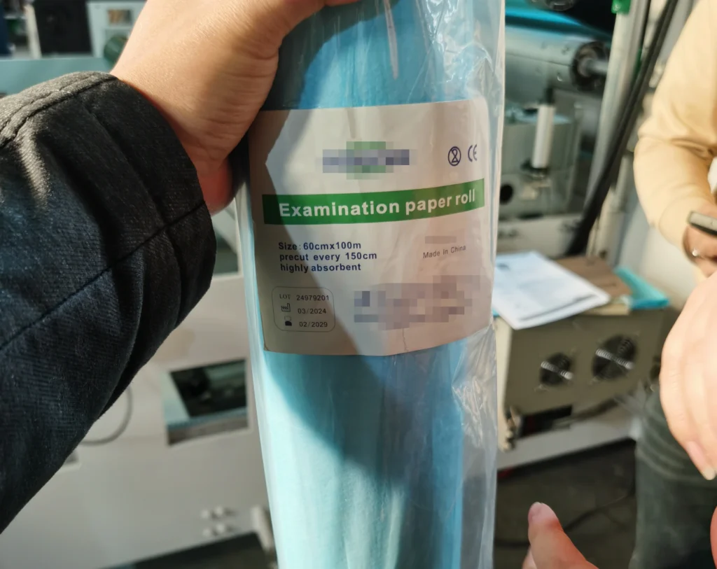 Disposable nonwoven medical examination table paper roll with tear perforation