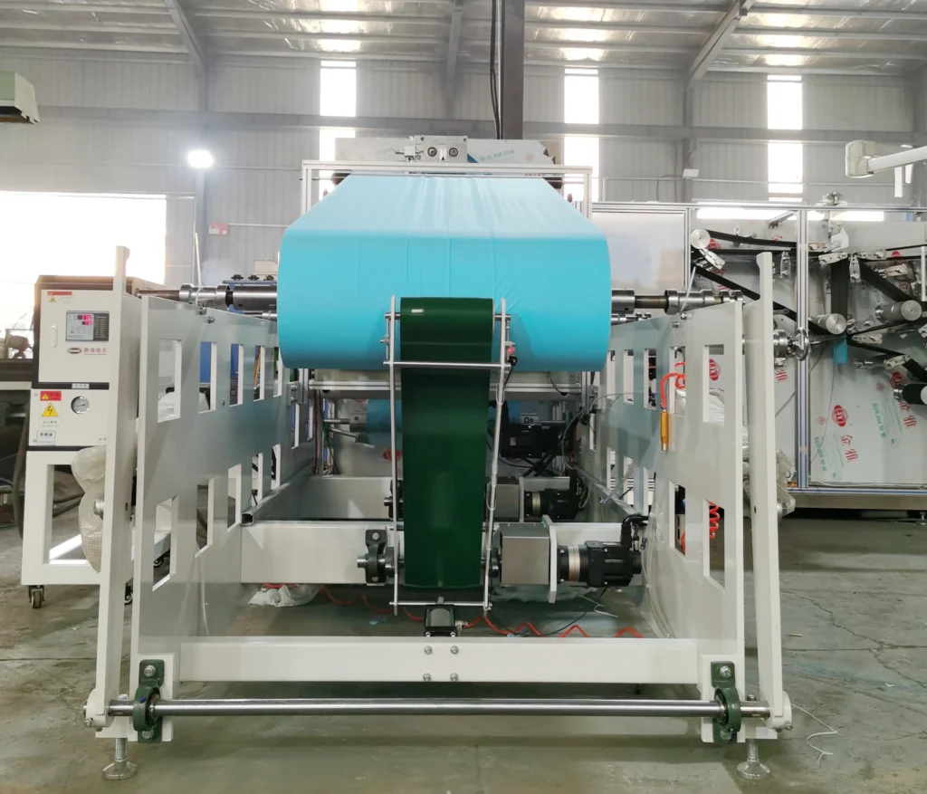 Pneumatic shaft unwind station for medical drape master rolls, featuring closed-loop magnetic powder brake tension control