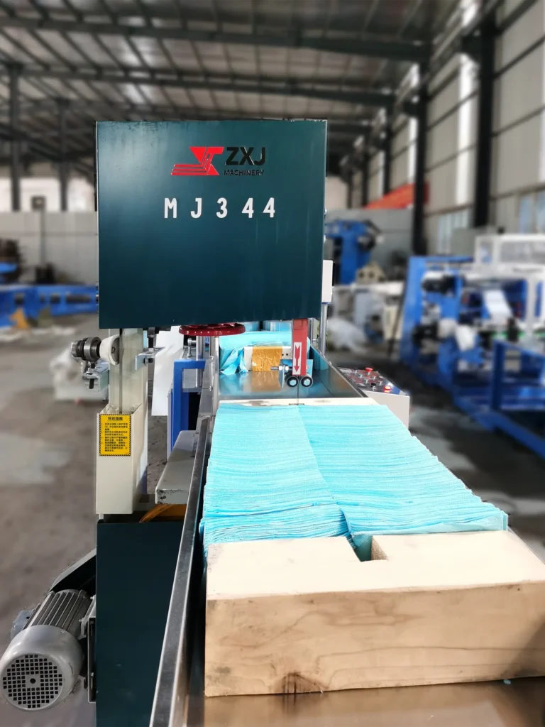 Dental bibs converting machine for producing disposable dental bibs