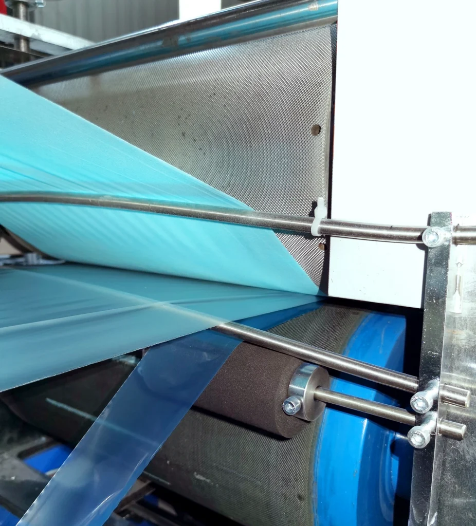 Dental bibs converting machine for producing disposable dental bibs