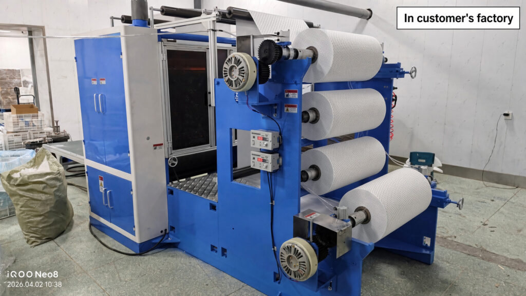 thin absorbent paper roll loaded on a perm paper folding machine unwind stand