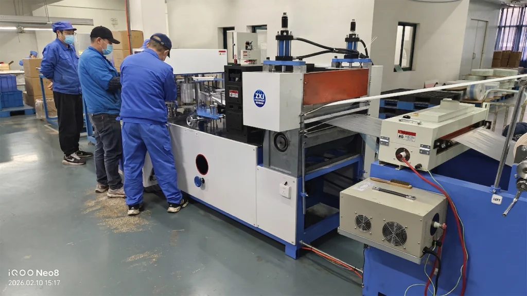 Dental bibs converting machine for producing disposable dental bibs